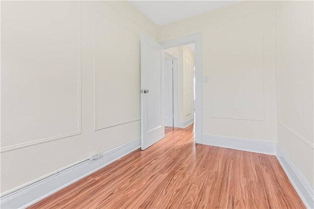 spare room featuring light hardwood / wood-style floors