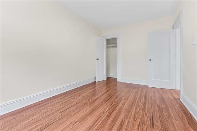 unfurnished bedroom with light hardwood / wood-style floors and a closet