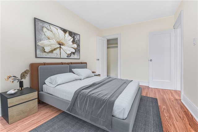 bedroom featuring hardwood / wood-style flooring and a closet