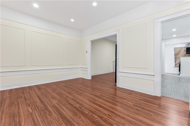 spare room with hardwood / wood-style floors