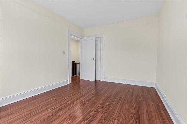 spare room with dark hardwood / wood-style flooring