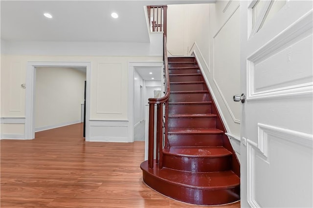 stairs featuring hardwood / wood-style flooring