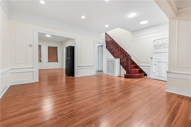 unfurnished living room featuring hardwood / wood-style floors