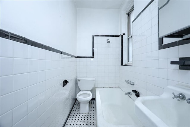 bathroom featuring tile patterned flooring, sink, tile walls, and toilet