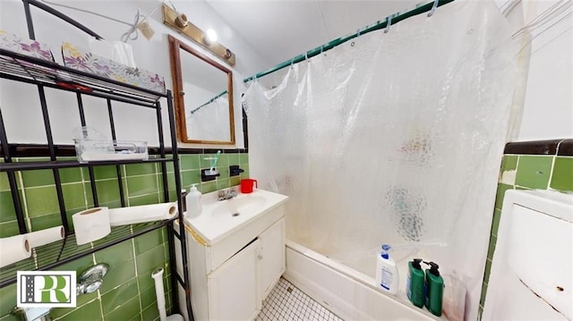 1046 E 32nd St, Brooklyn, NY 11210 - full bathroom featuring tile walls, vanity, shower / tub combo with curtain, and tile patterned flooring