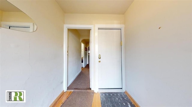 view of exterior entry featuring a wall unit AC