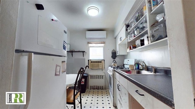 1046 E 32nd St, Brooklyn, NY 11210 - kitchen with radiator, white range with gas stovetop, a sink, light floors, and a wall mounted AC