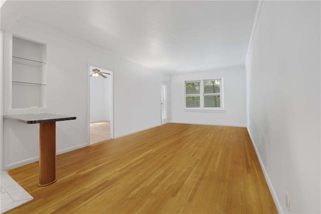 unfurnished living room featuring light wood-style floors and baseboards