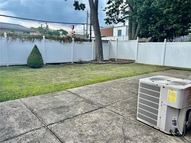 view of yard with cooling unit and a patio