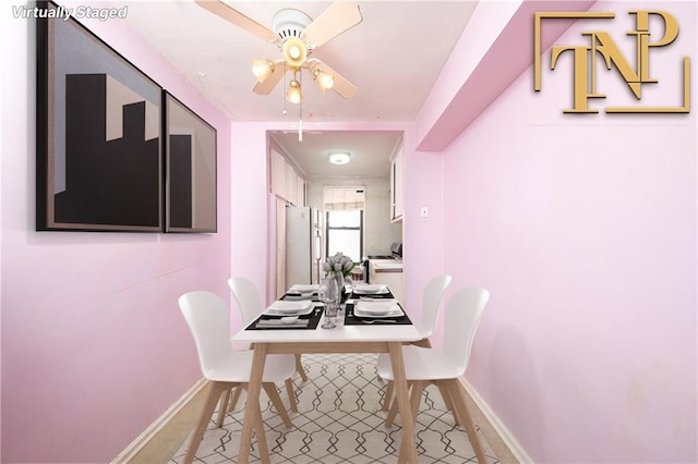 dining room featuring ceiling fan, baseboards, and light tile patterned floors