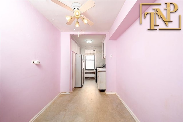 hall with light floors, baseboards, and washer / dryer