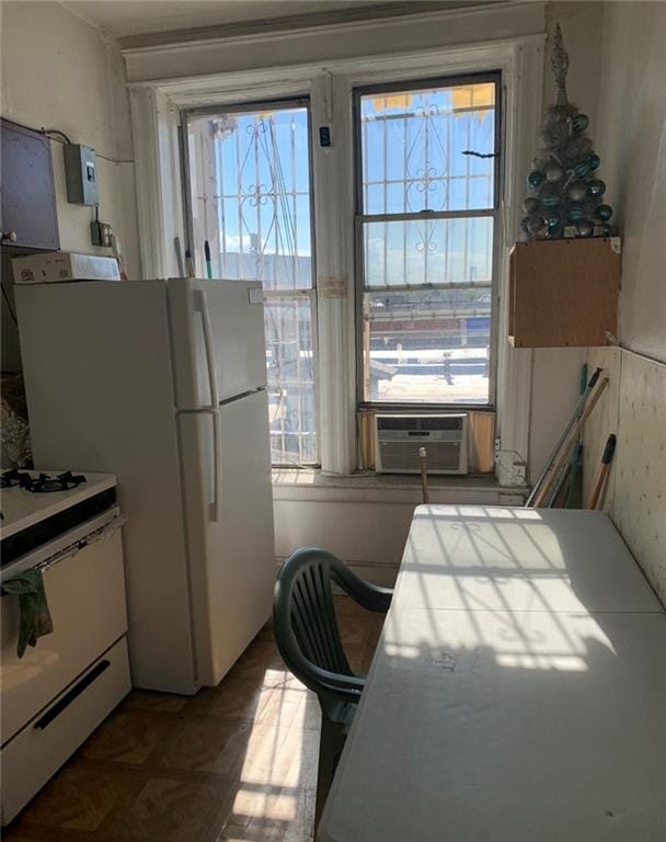 kitchen featuring tile countertops, white range with gas stovetop, and cooling unit