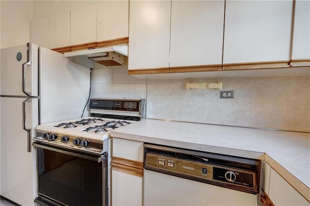 1478 E 28th St Unit 4N, Brooklyn, NY 11210 - kitchen featuring white appliances, under cabinet range hood, light countertops, decorative backsplash, and white cabinetry