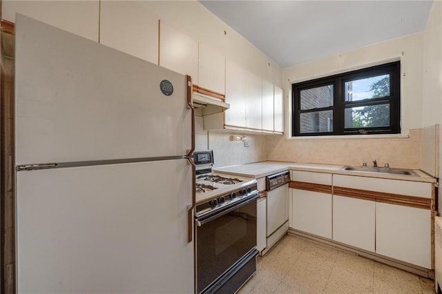 1478 E 28th St Unit 4N, Brooklyn, NY 11210 - kitchen with white appliances, a sink, light flooring, light countertops, and under cabinet range hood