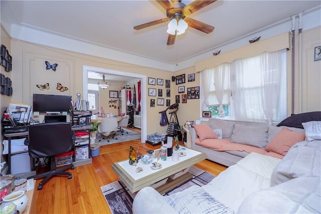 living area with ceiling fan and wood finished floors