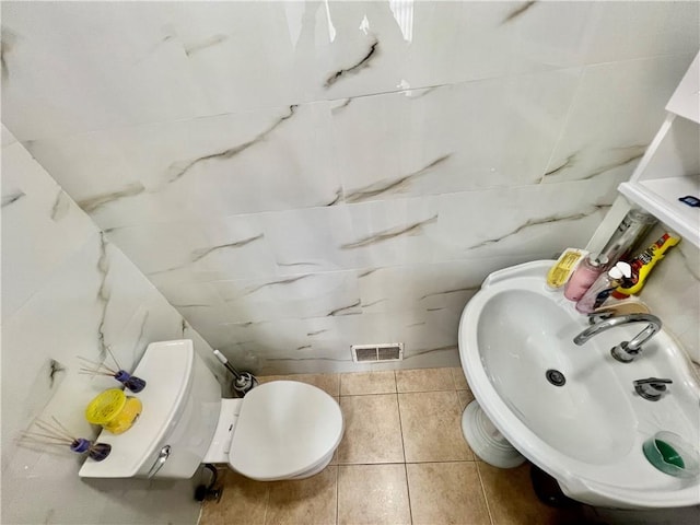 bathroom with tile patterned floors, toilet, and sink