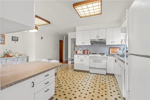 kitchen with white cabinetry, white appliances, and tasteful backsplash