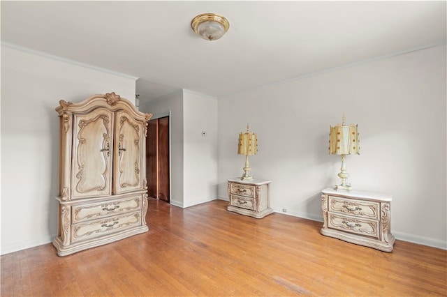 miscellaneous room featuring hardwood / wood-style flooring and crown molding