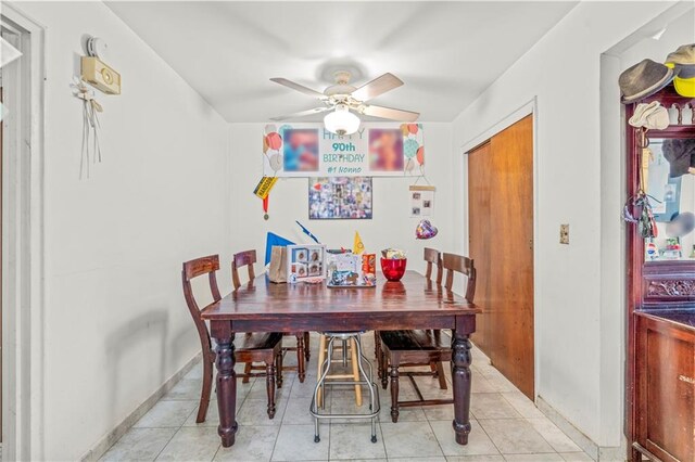 dining room with ceiling fan and light tile patterned floors