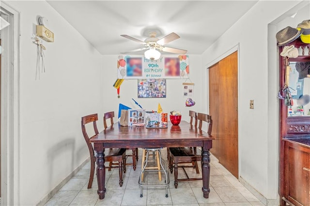 tiled dining area featuring ceiling fan