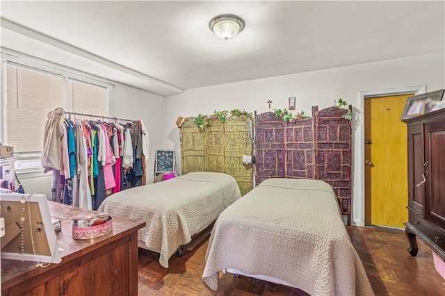 bedroom with dark parquet flooring