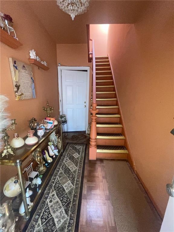 doorway featuring a chandelier and dark hardwood / wood-style floors