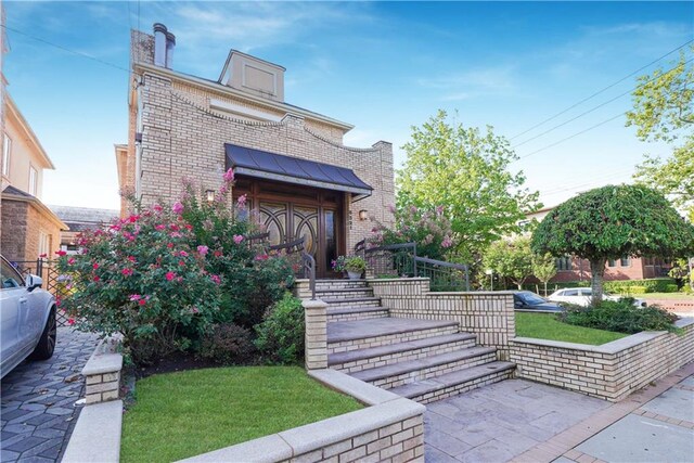 doorway to property with a yard