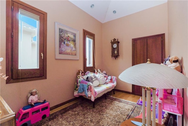 bedroom with hardwood / wood-style flooring and vaulted ceiling