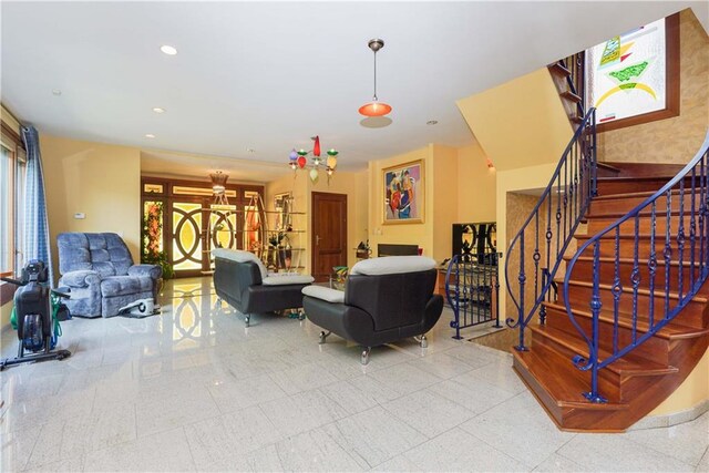 living room with an inviting chandelier and french doors