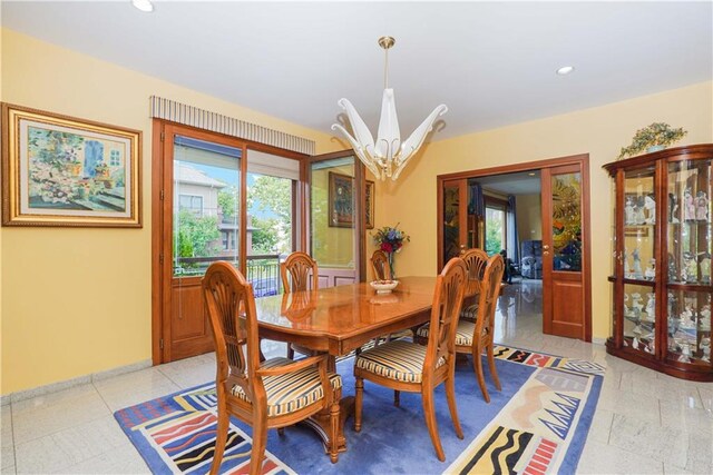 dining room with a healthy amount of sunlight and a notable chandelier