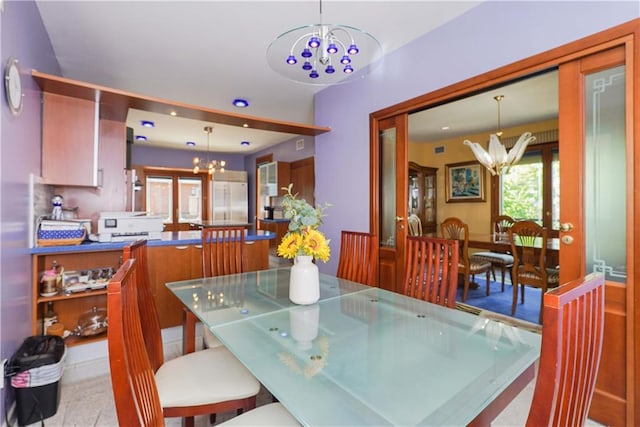 tiled dining space with a chandelier