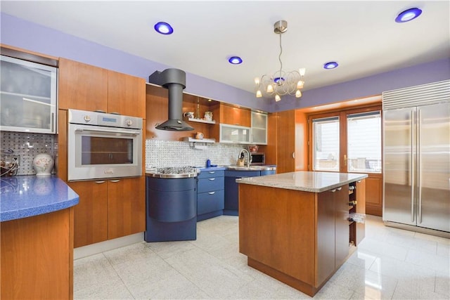 kitchen featuring backsplash, a kitchen island, hanging light fixtures, and appliances with stainless steel finishes