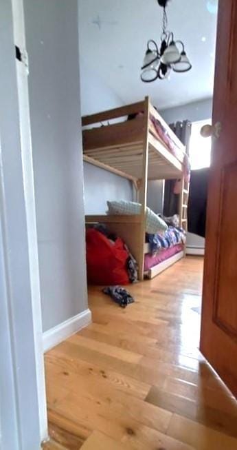 2319 W 12th St, Brooklyn, NY 11223 - bedroom with a chandelier and wood finished floors