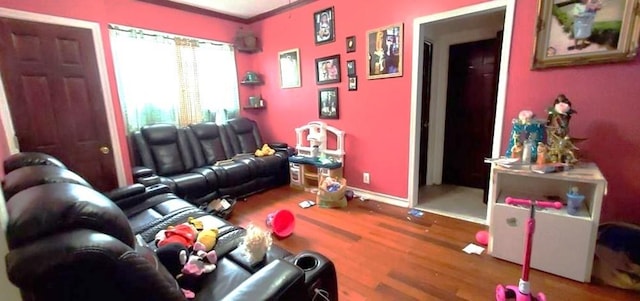 living room with crown molding and hardwood / wood-style flooring