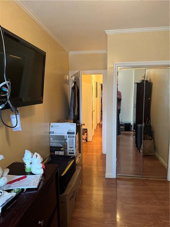 kitchen with ornamental molding and hardwood / wood-style floors