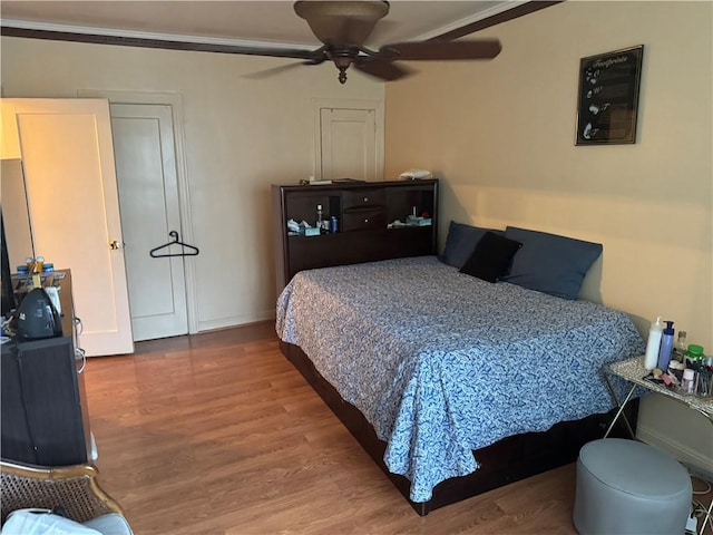 bedroom with hardwood / wood-style floors and ceiling fan