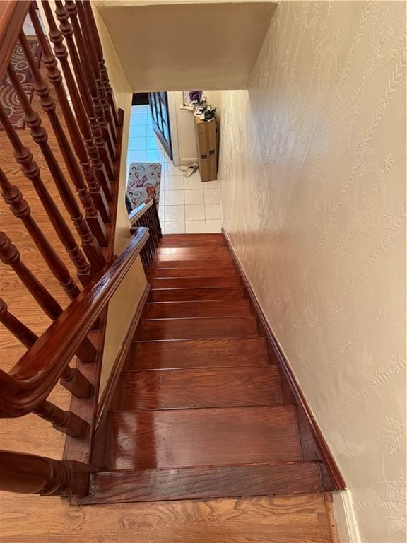 stairs with hardwood / wood-style flooring