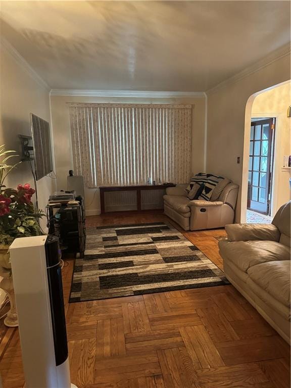 living room with crown molding and parquet flooring