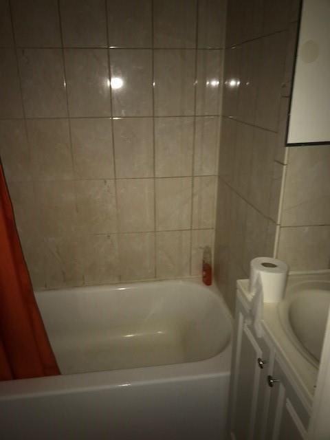 full bathroom with a bathtub, vanity, and a shower with shower curtain
