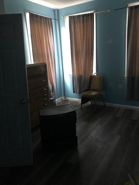 bedroom with wood finished floors and baseboards