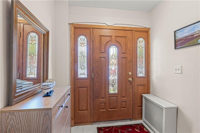 tiled foyer entrance with radiator heating unit