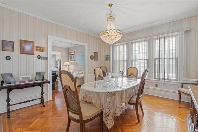 dining space featuring light parquet floors, ornamental molding, and a chandelier