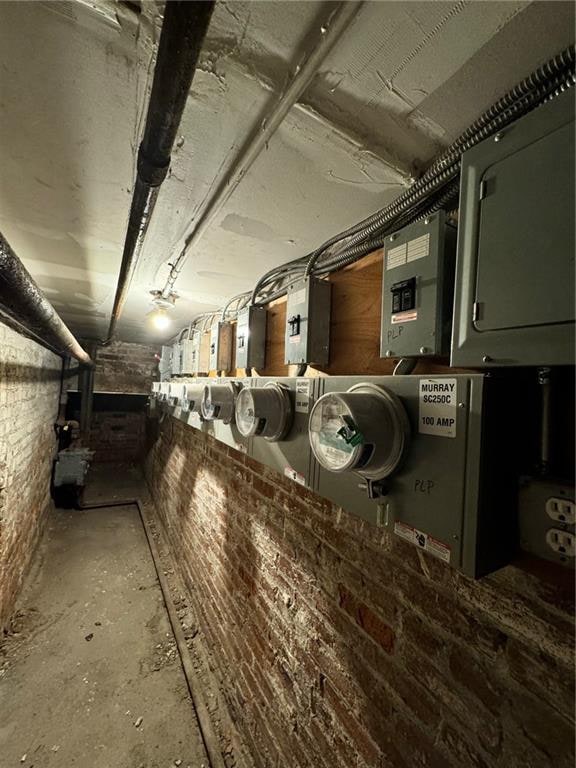 interior space featuring brick wall and electric panel