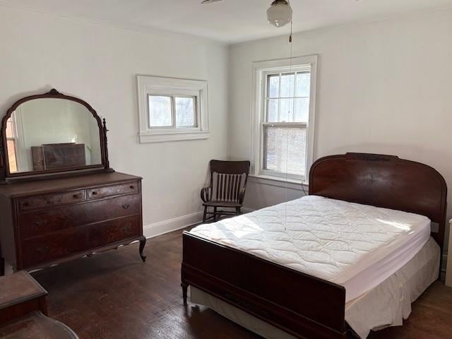 bedroom with wood finished floors and baseboards