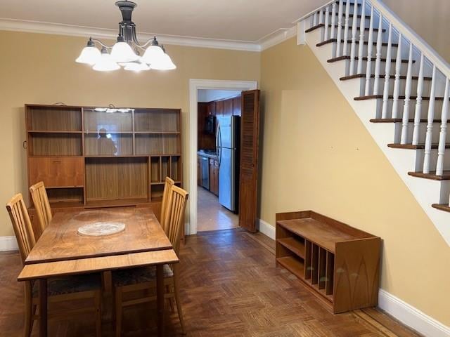 unfurnished dining area featuring an inviting chandelier, crown molding, stairway, and baseboards