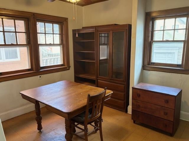 dining area featuring a ceiling fan and baseboards