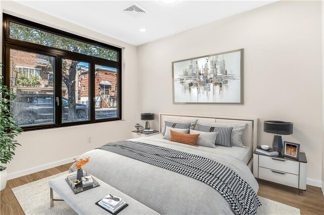 207 Bay 35th St Unit 2B, Brooklyn, NY 11214 - bedroom featuring baseboards, wood finished floors, and recessed lighting