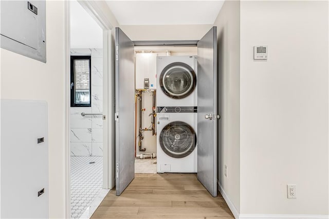 207 Bay 35th St Unit 2B, Brooklyn, NY 11214 - washroom with stacked washer and clothes dryer and light wood-style floors