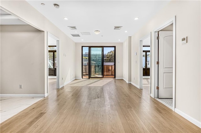 spare room with light wood finished floors, visible vents, recessed lighting, and baseboards