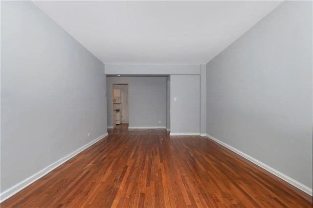 empty room with dark wood-type flooring